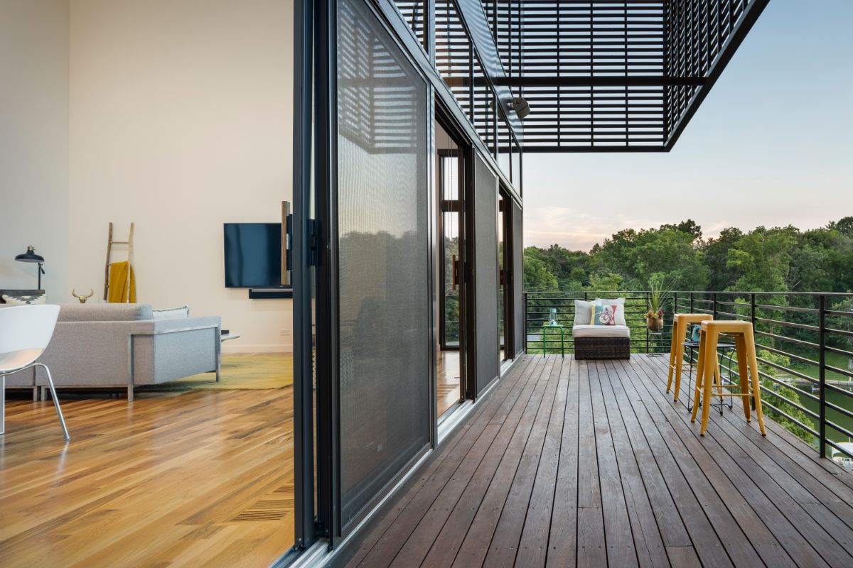 A terrace in the wood clad volume with unobstructed lake views.