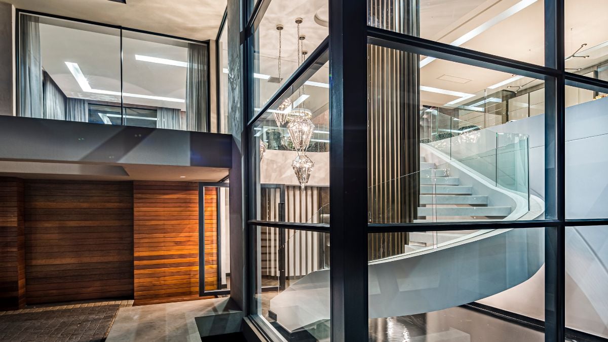 As you first enter the house, you are greeted by an interior rain feature where water accumulates in a big interior/exterior water feature that serves as the base of a beautiful sculptural stairway.