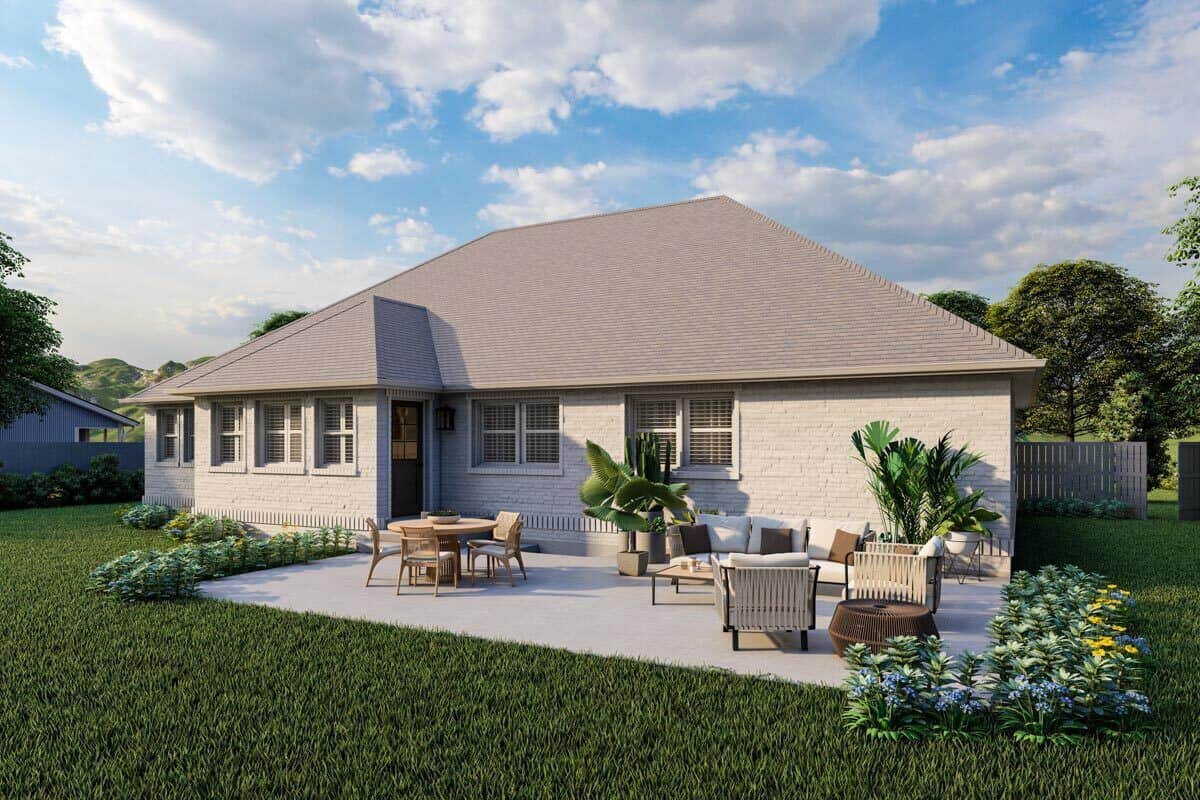 Rear rendering with a spacious concrete patio filled with outdoor living and dining.