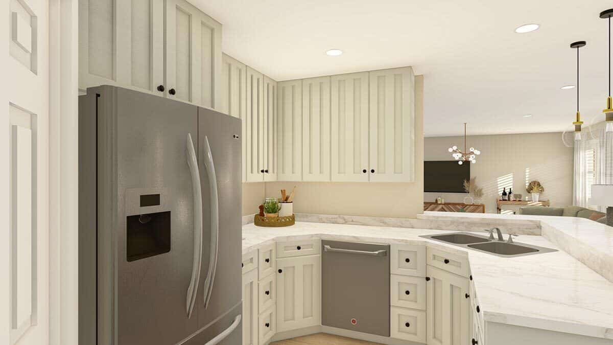 The kitchen has cream cabinets, stainless steel appliances, and an angled peninsula topped with a raised eating bar.