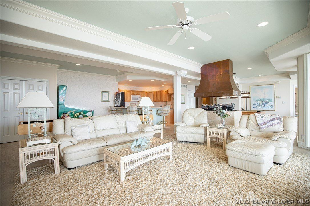 The sitting room features a sectional sofa and a carpet giving off a cozy feel.