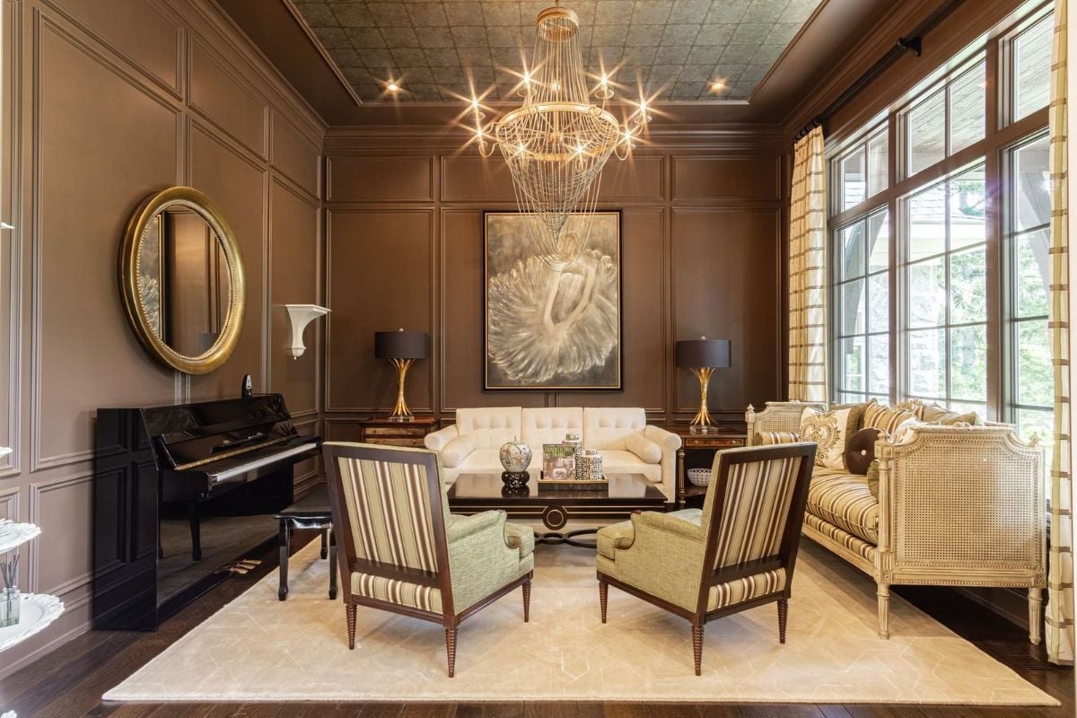 The sitting room features an area rug and a sofa beside the glass windows.