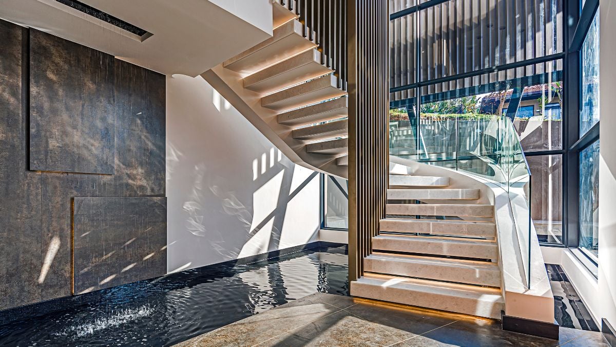 You are drawn easily to the main living level of the house by the sensual curve of the stairway that spirals up and over the river below.