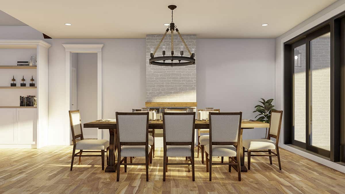 Dining area with beige upholstered chairs and a wooden dining table topped with a round chandelier.