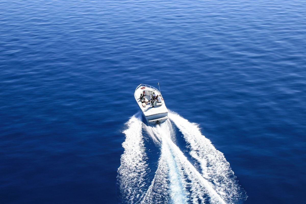 People on a small boat enjoy boating together in the lake.