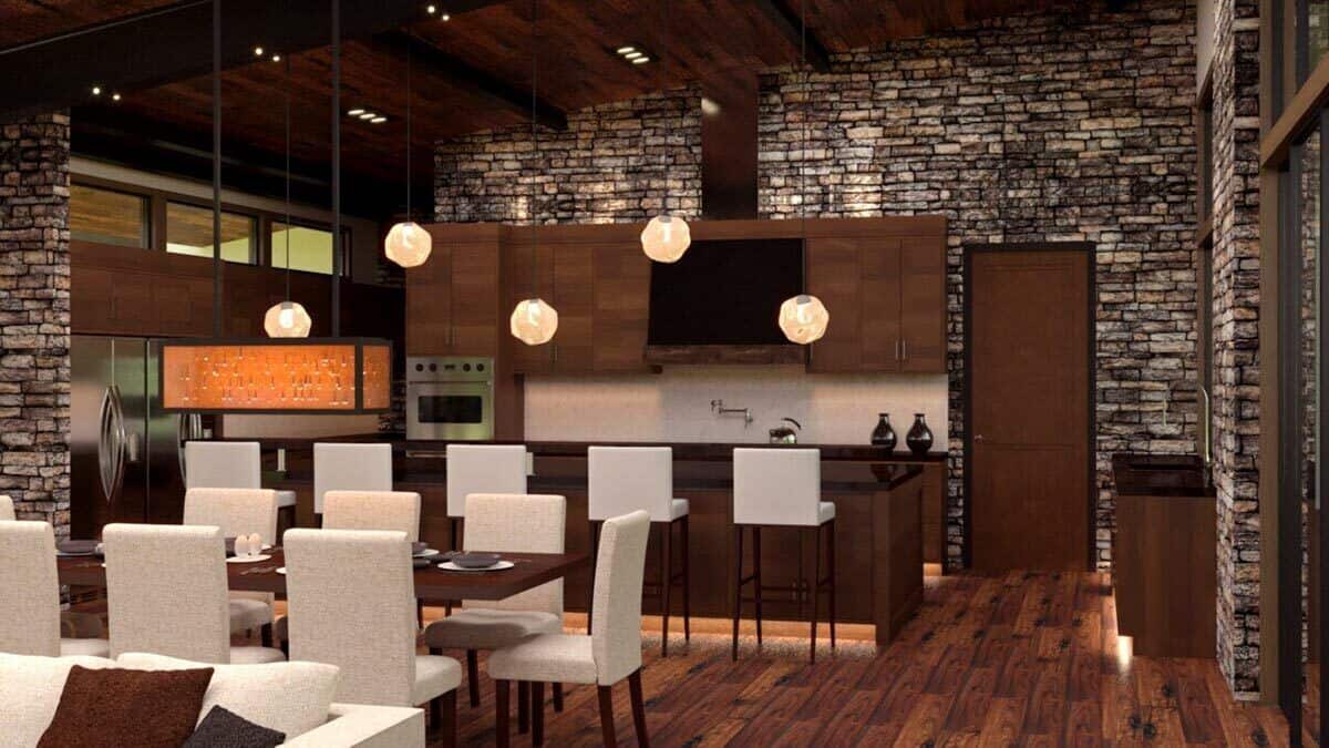 Warm pendants illuminate the kitchen. It includes a breakfast island and wooden cabinets that blend in with the hardwood floor.