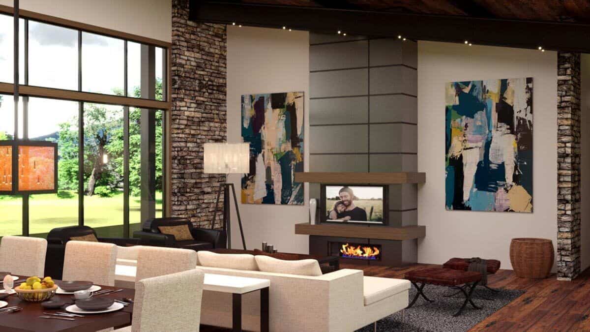 The living room features modern seats and a fireplace topped with a TV. Brick accents add texture to the area.