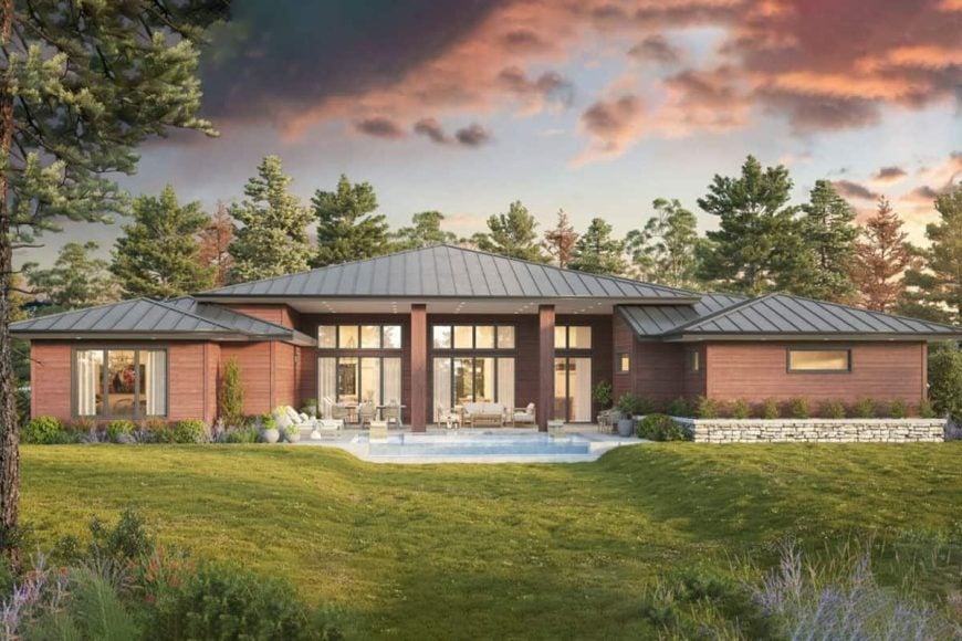 A single-story home with a sleek design, surrounded by lush greenery and featuring a stylish outdoor seating area.