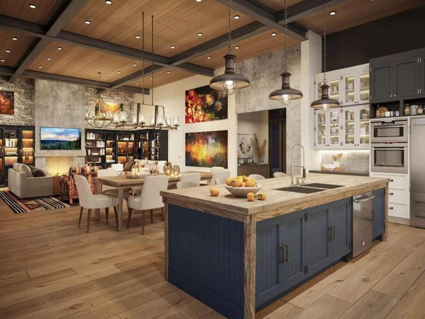 Open-concept kitchen and dining area with rustic wooden accents, a blue island, and warm lighting.
