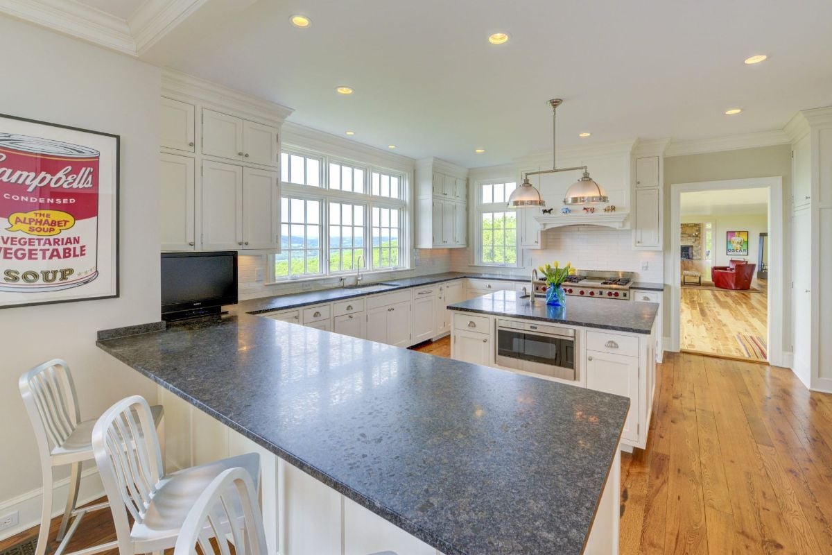 The kitchen features a bi-level kitchen island with a granite countertop.