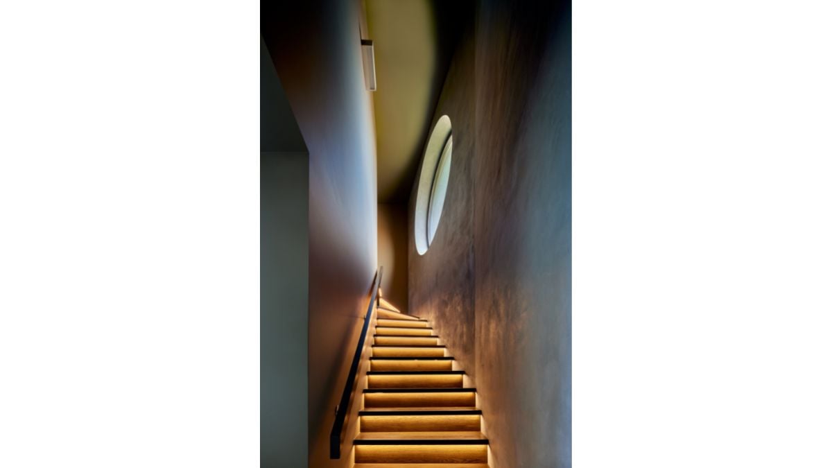 There is only one round window in the house's north side near the stairs.