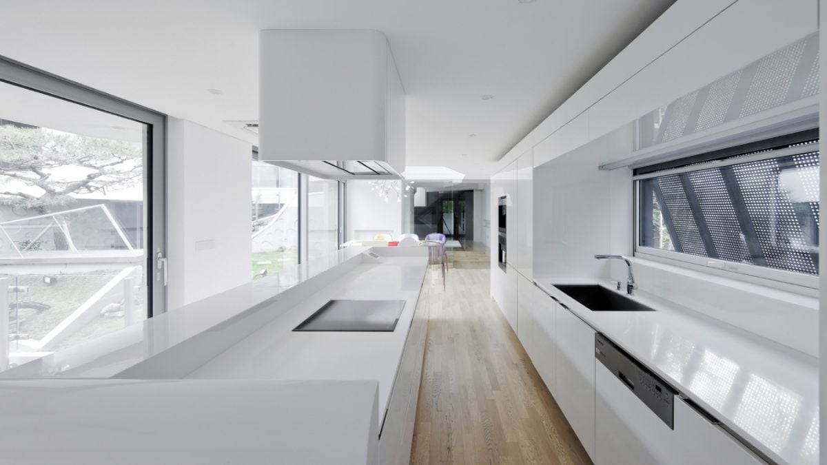 The entire kitchen space is white, from the ceiling down to the appliances.