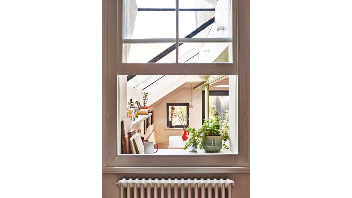 The retained window cill in the kitchen serves as a shelf because of the difference in level between the home and the addition.