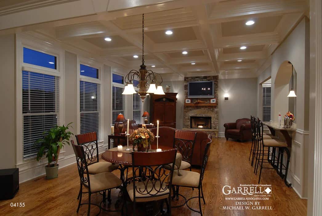 Breakfast nook with a round dining table surrounded by ornate wrought iron chairs.