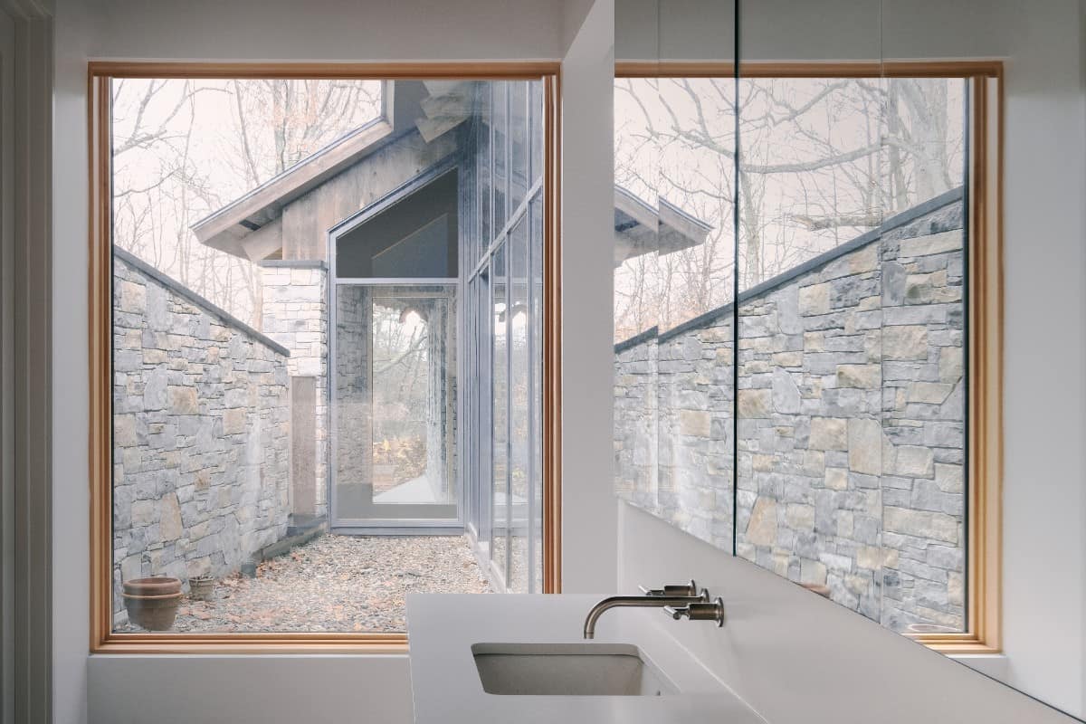 The bathroom has modern fixtures and great views of the courtyard.