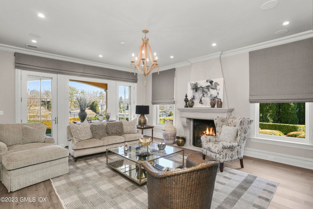 The fireplace room exuded a sense of warmth and comfort, as the roaring fire in the hearth filled the air with a cozy heat that enveloped me as I lounged on the plush sofa, lost in the mesmerizing dance of the flames.