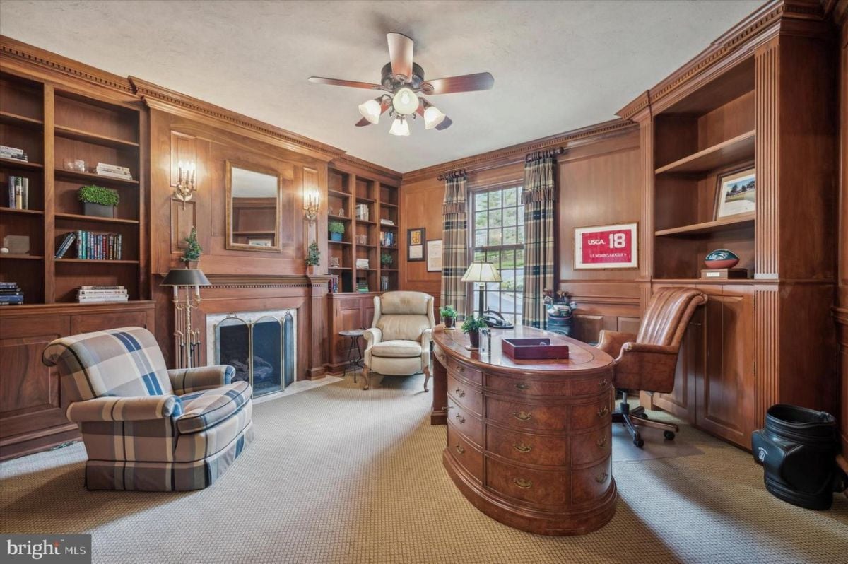 The study was equipped with a sturdy wooden office table and lined with wall-to-wall carpeting, providing a comfortable and practical space for work and productivity.