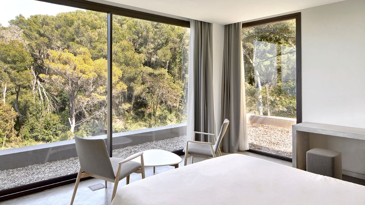 The tranquility of this bedroom is reflected in its comfortable bed and visible vista.