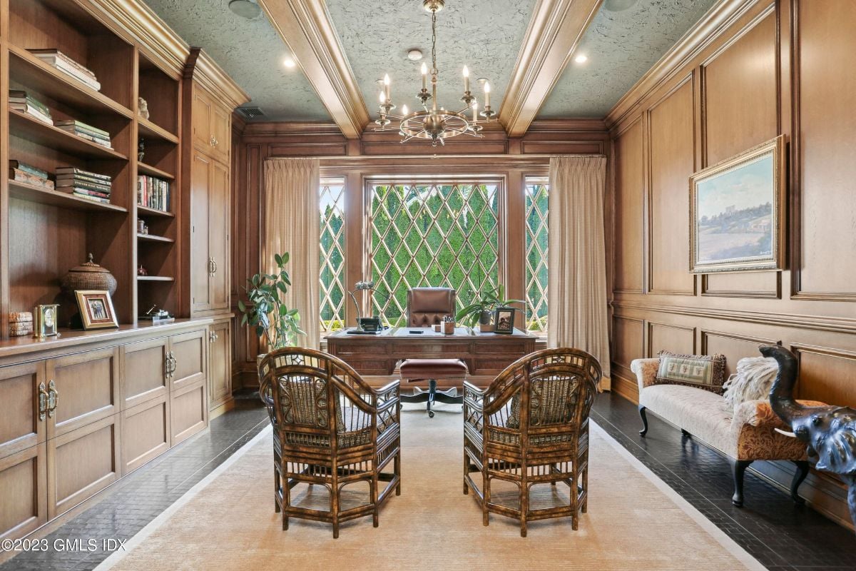 The study was a serene retreat, complete with an impressive wooden office table that served as the focal point of the room.