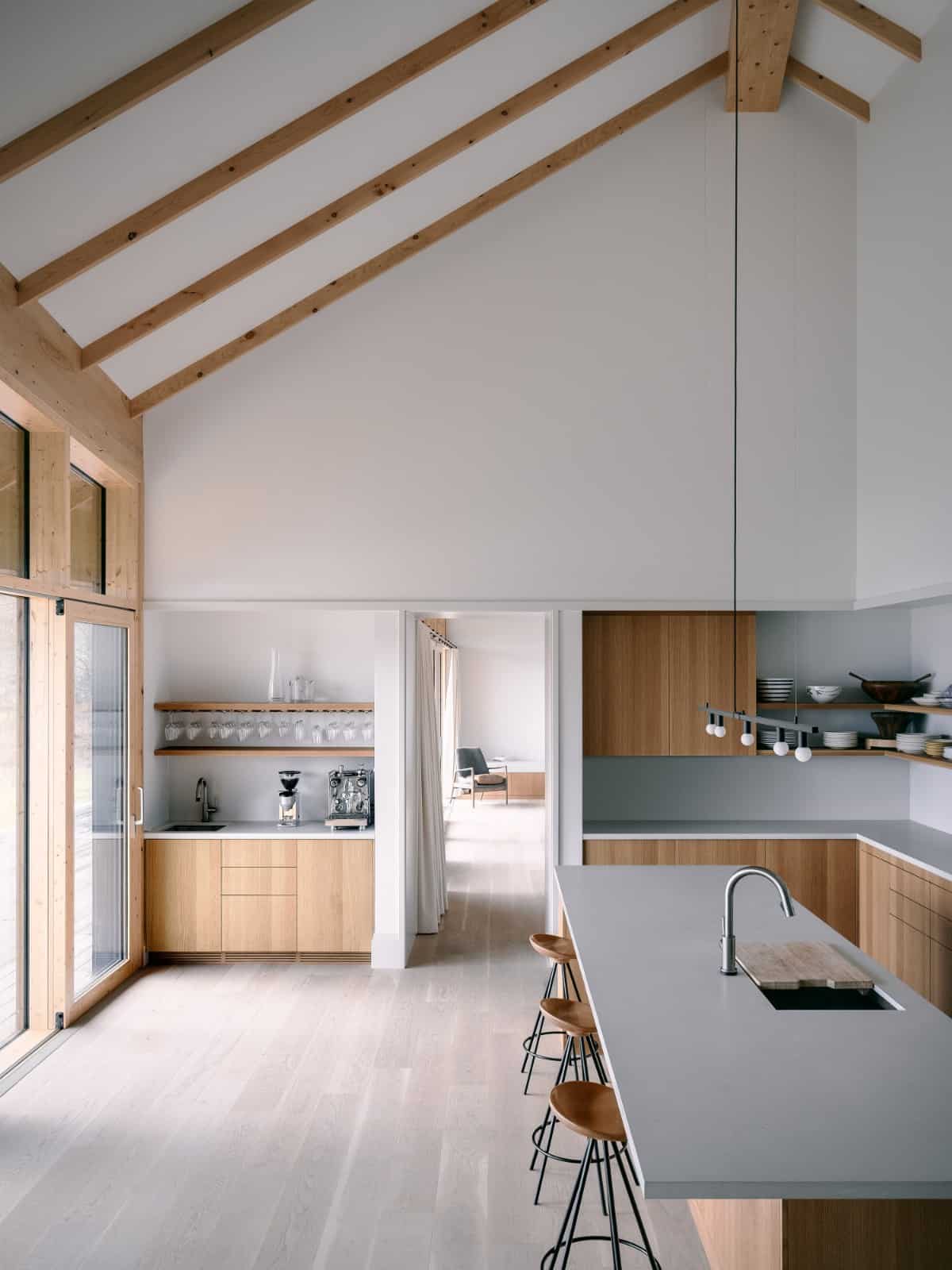 A vaulted ceiling framed with exposed beams crowns the kitchen.