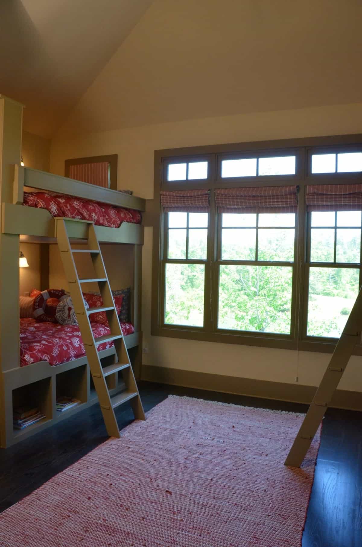 This bedroom offers two bunk beds under a cathedral ceiling.