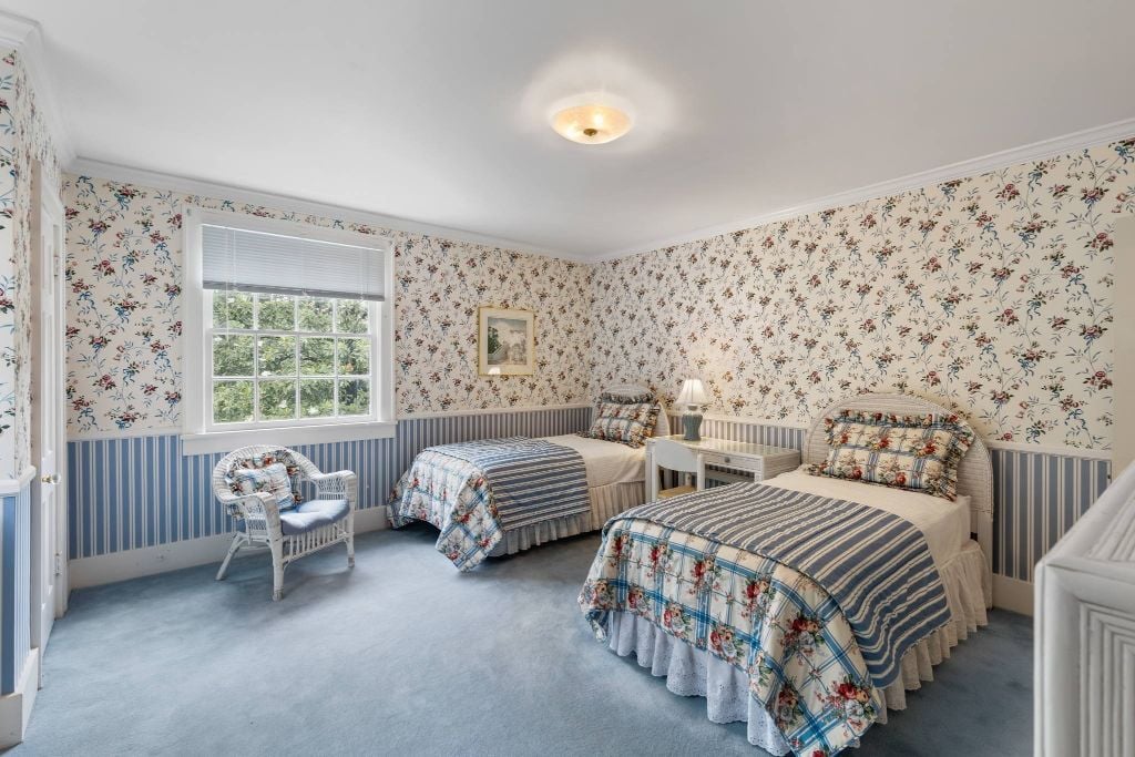Original hardwood floors are under the carpet in this bedroom. Room to expand and add a bath on the adjacent flat roof area.