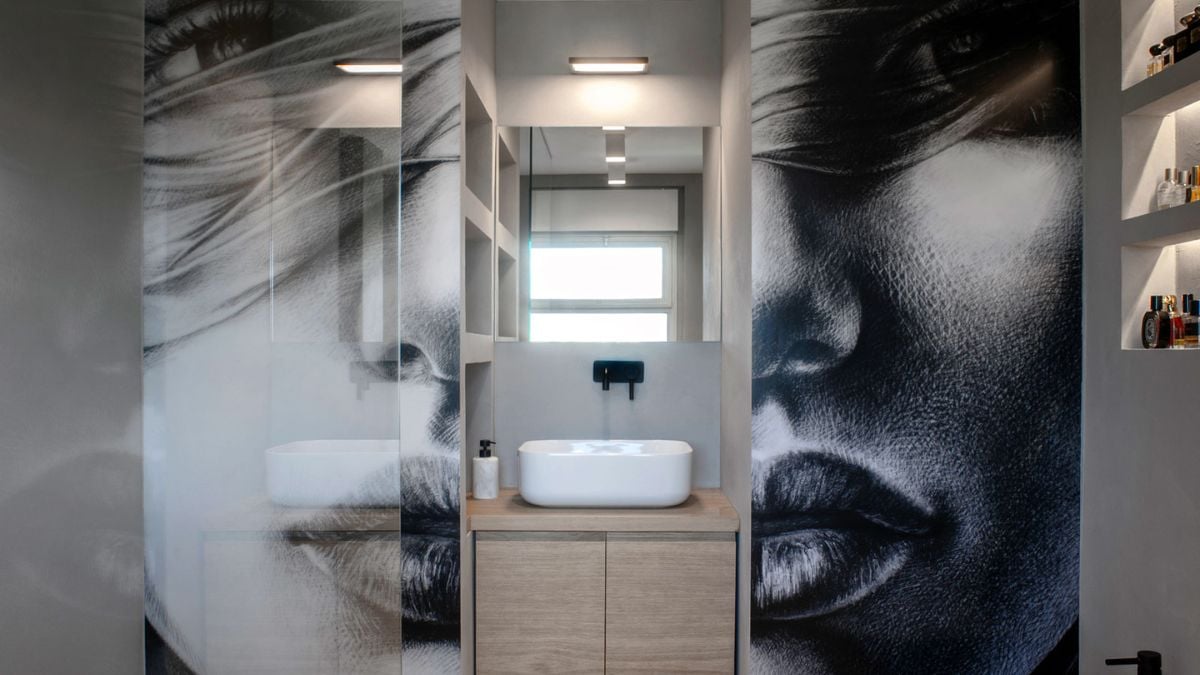 A wonderful piece of printed art on plexiglass has been mounted on the walls of the master bathroom as decor.