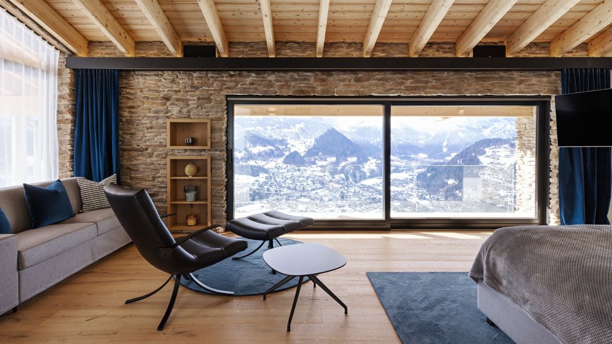 The bedroom's huge glass windows provide fantastic mountain views.