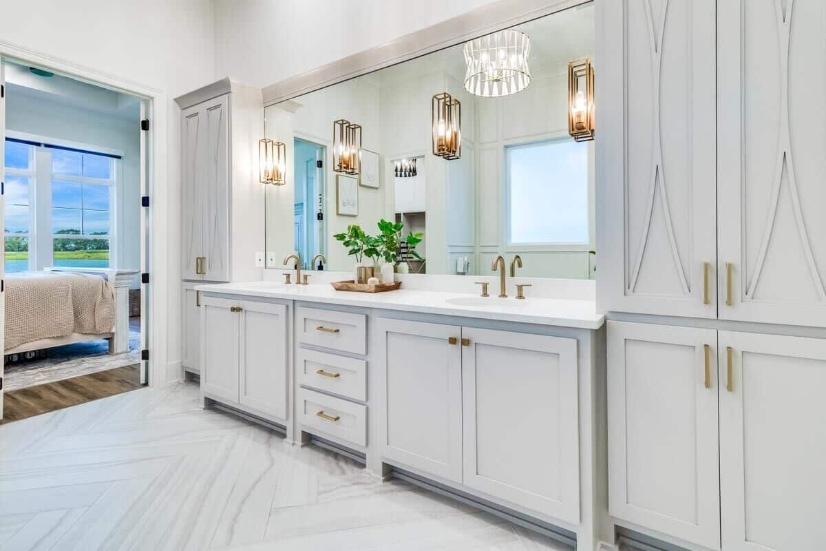 The primary bathroom includes a dual sink vanity with full-height cabinets on either side.