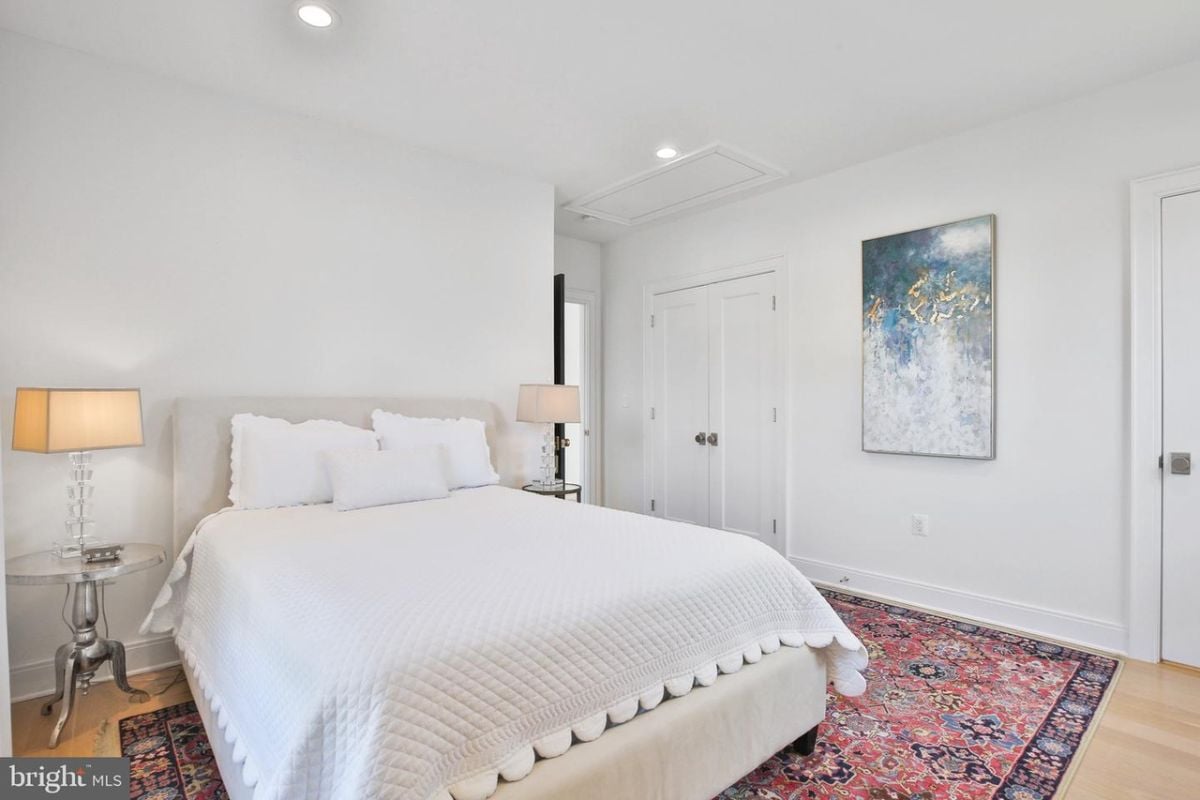 The comfortable queen-sized bed was softly illuminated by a gentle night lamp, creating a cozy and peaceful atmosphere that made it easy to unwind and drift off to sleep.