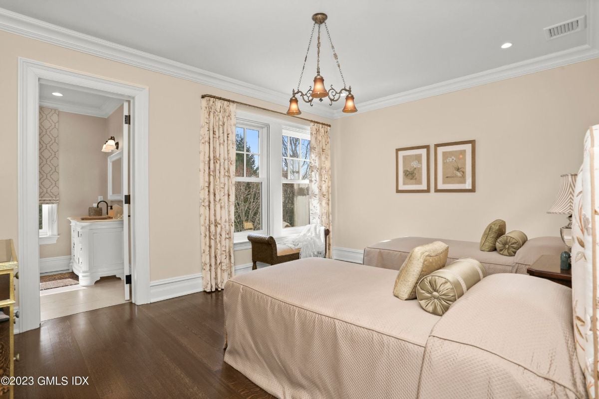 The spacious bedroom was tastefully appointed with two comfortable single beds, perfectly arranged to ensure a good night's rest, making it the ideal space for guests or siblings to relax and unwind in comfort and style.