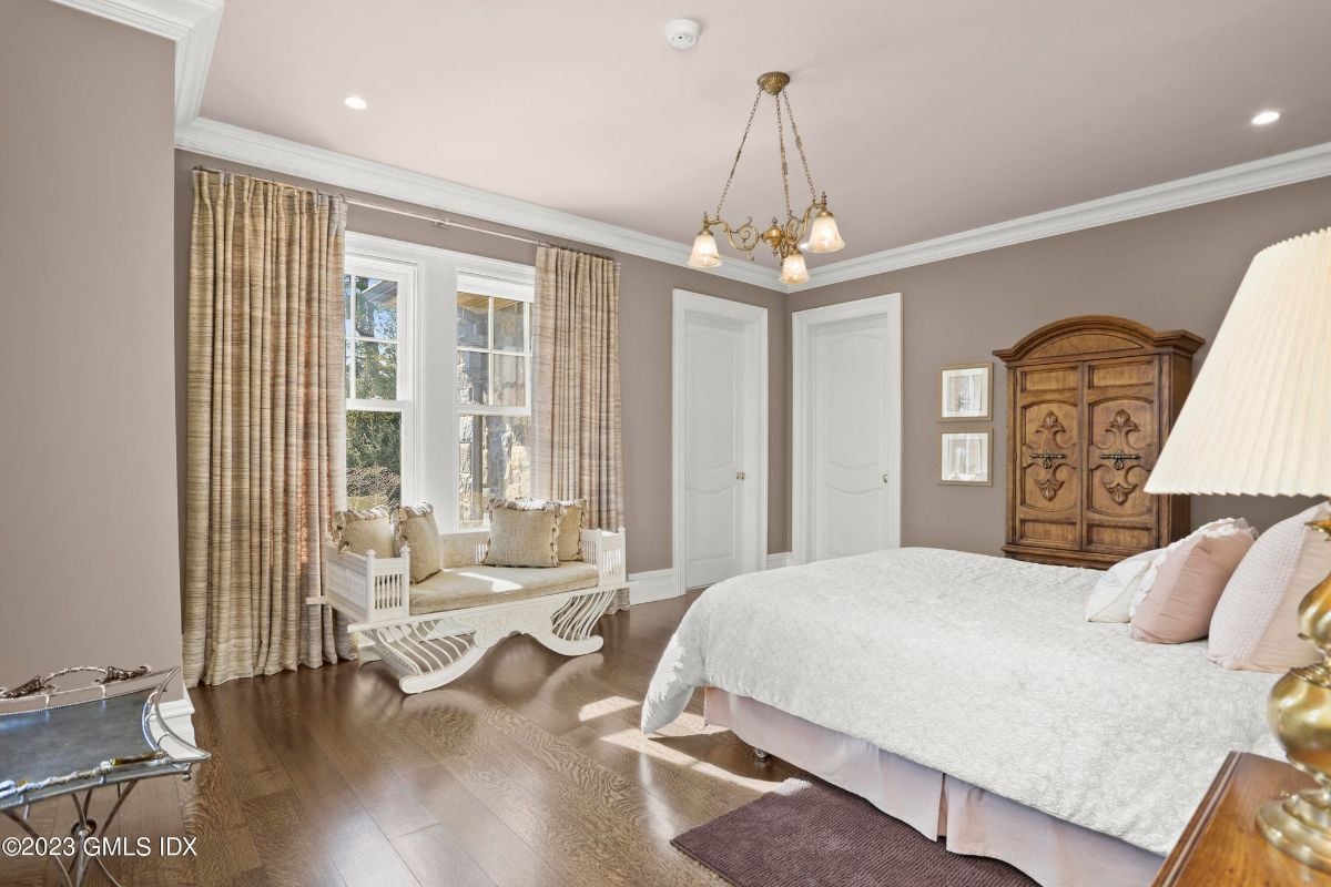 In the bedroom, the cozy window seat was bathed in natural light that filtered through the delicate curtains, offering a peaceful nook to read or enjoy a cup of tea while basking in the warmth of the sun.
