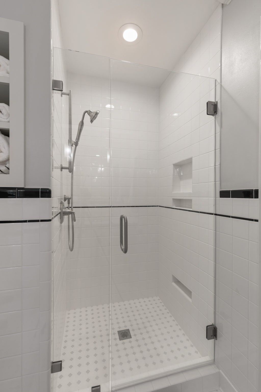 Large walk-in shower with glass door is part of the renovations this home has seen.