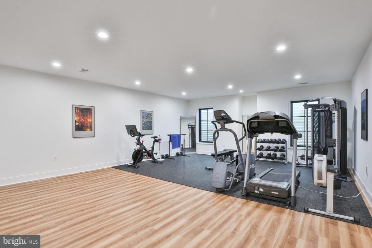 The home gym features multiple gym equipment for a variety of workout options.