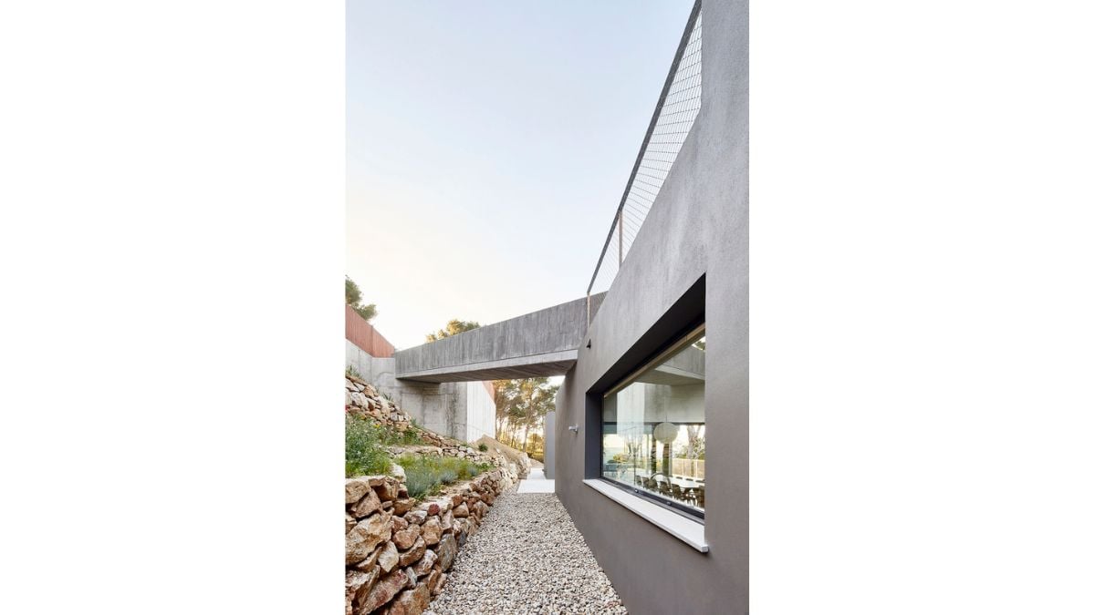 The exterior of the house is painted a dark chocolate brown to better blend in with the rocks and pine trees that make up the environment.