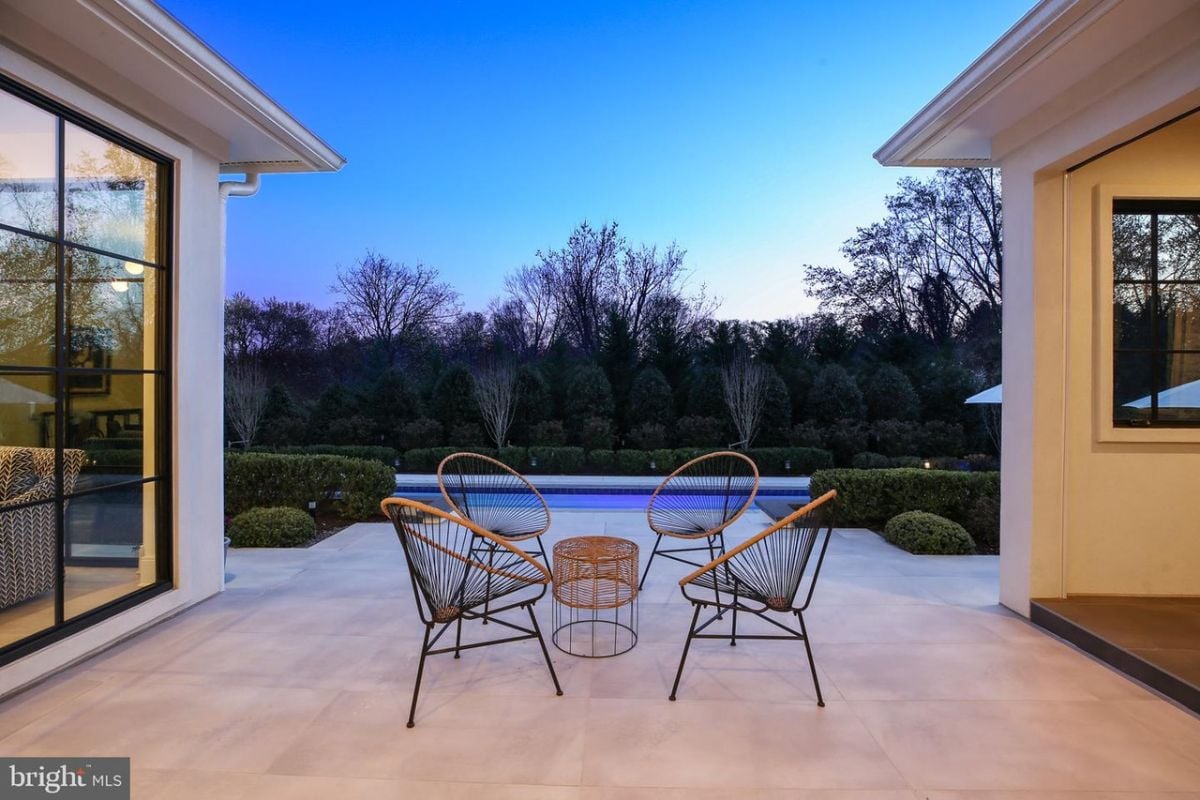 The spacious patio offers a stunning view of the sparkling lap pool.