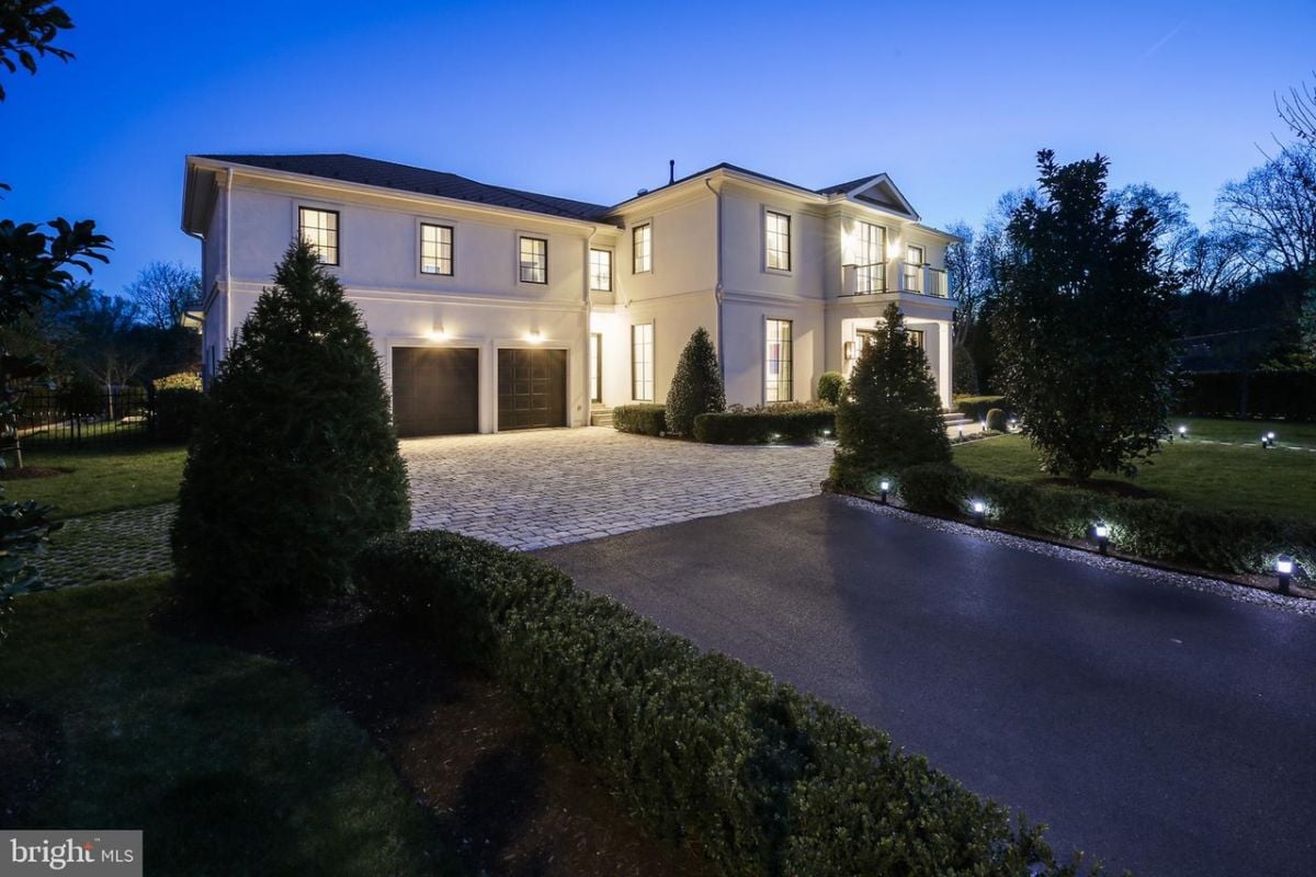 The elegant stone driveway leads to the attached garage, adding a touch of sophistication to the property.