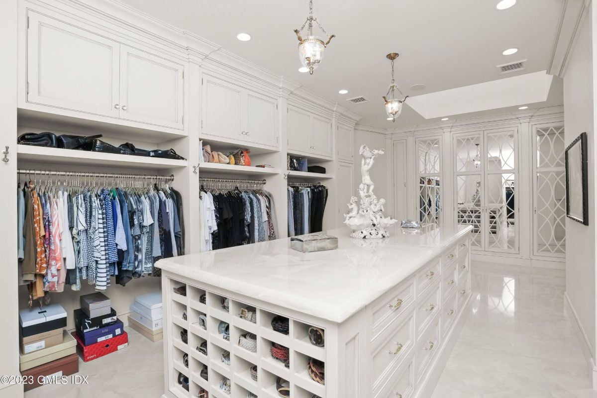 The expansive walk-in closet was a fashion-lover's dream, complete with a closet island that featured ample storage space and a sleek, polished finish.