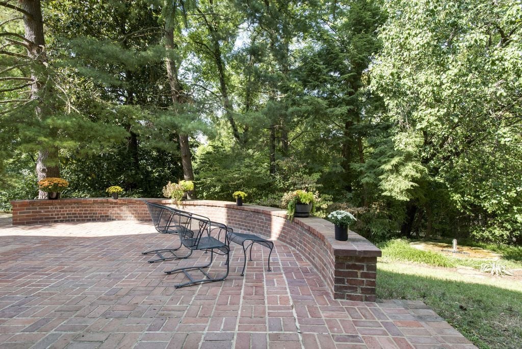 More brick patios to the east. This one overlooks a stone water feature. Imagine the garden party you could have here.
