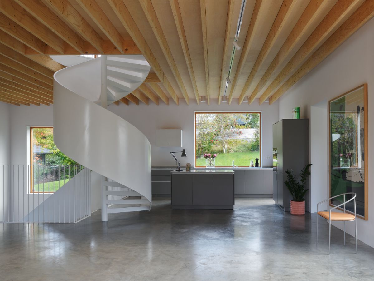 The kitchen, located near the central spiral stair, features clean-lined materials and fixtures.