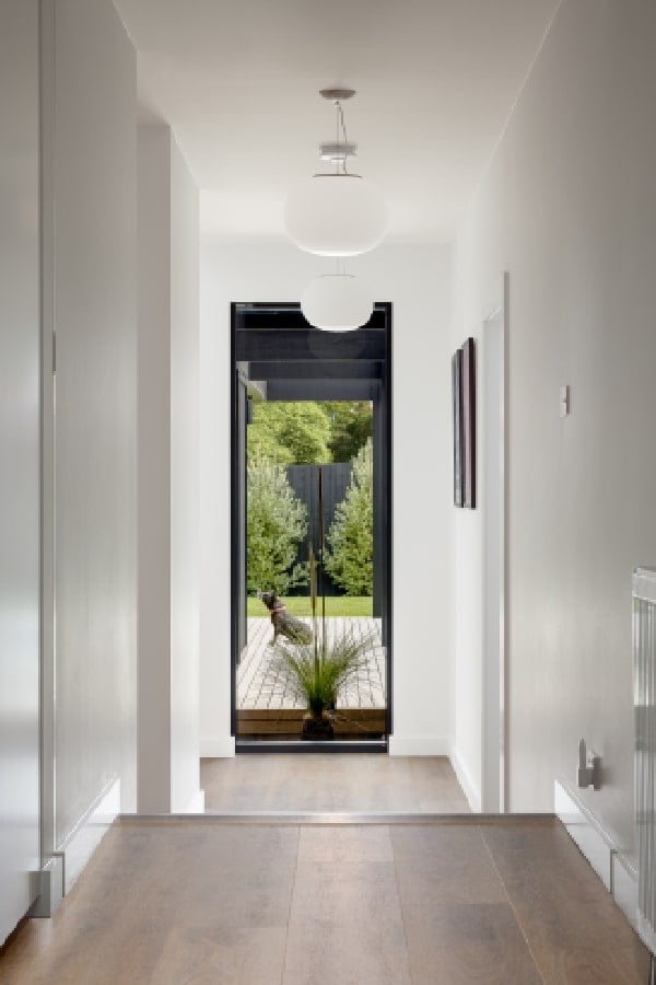 A hallway with a view of the outside landscaping.
