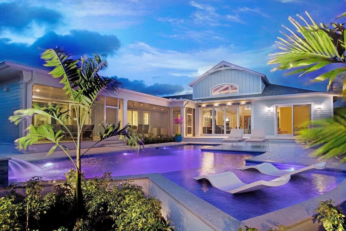 At night, the illuminating pool enhances the home's ambiance.