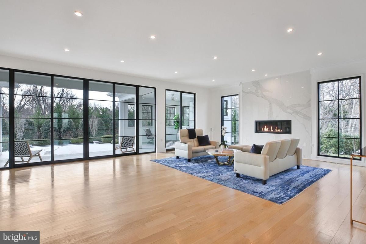 The cozy living room was furnished with a plush sofa positioned in front of the warm fireplace.