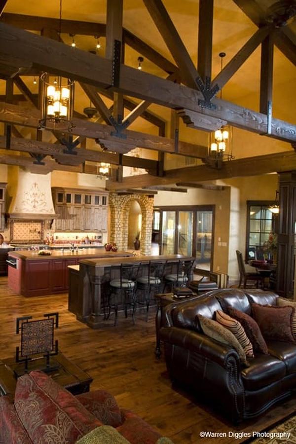 An open layout view showing the kitchen, hearth room, and breakfast nook under the beamed ceiling.