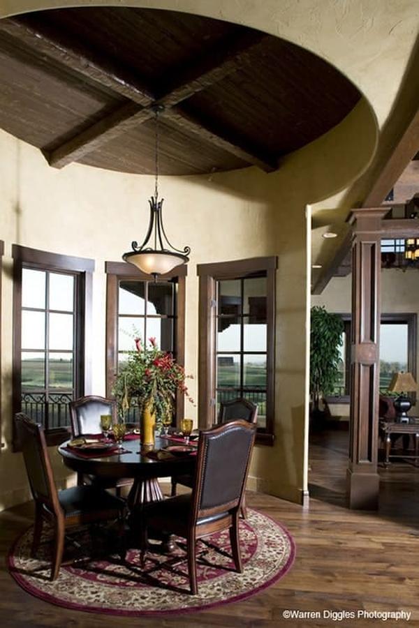 Breakfast nook with a glass dome pendant, a round dining set, and a red bordered rug.