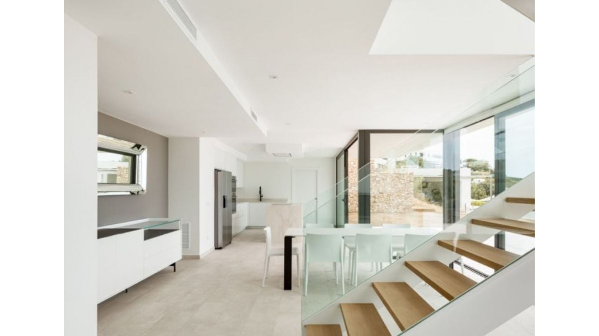 Family life is conducted in the lower floor's open-concept living, dining, and kitchen areas, as well as a study.