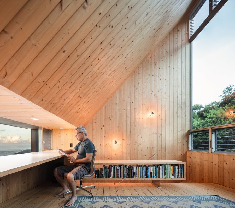 A home office on the fin structure as an extension above the round shape house with a panoramic view of nature.