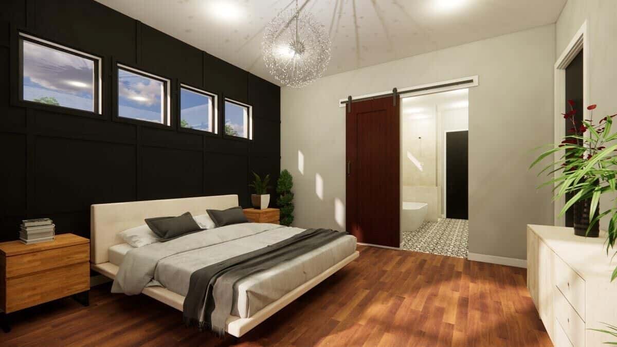 Sliding barn door across the bed reveals the primary bathroom.