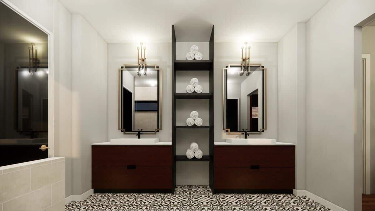 Primary bathroom with his and her sink vanities separated by built-in shelves.