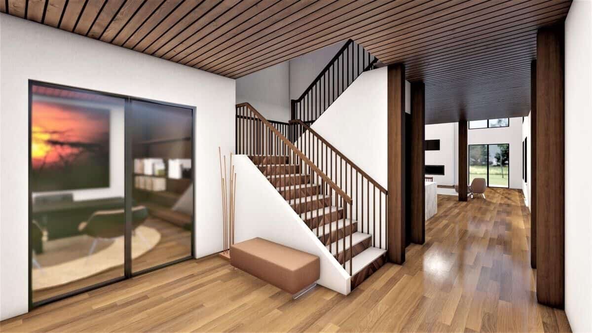 Foyer with an upholstered bench, a staircase, and a French door that reveals the home office.